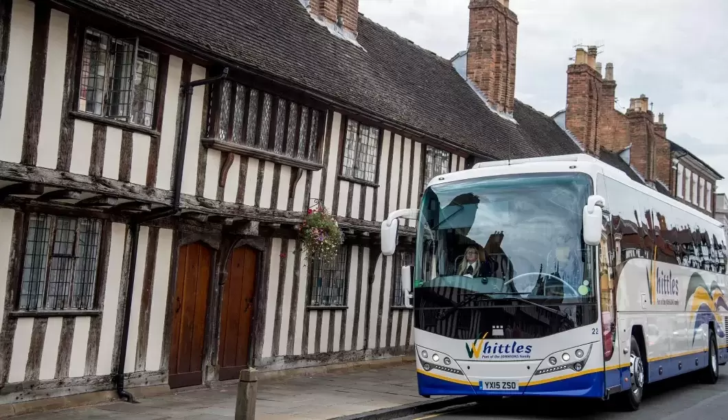 Whittles coach infront of Tudor house