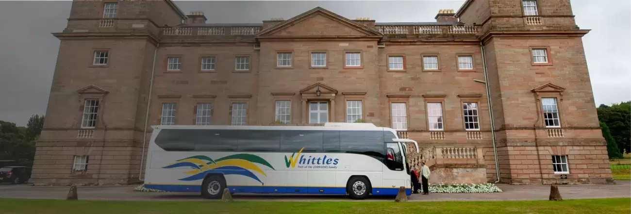 Whittles coach side view infront of building